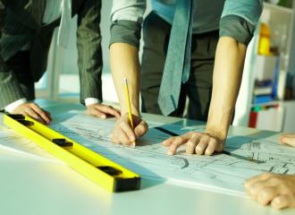 Building project design team marking up plans