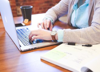 Lady using a laptop with a cup of tea