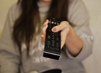 Woman hold a remote control and pointing it
