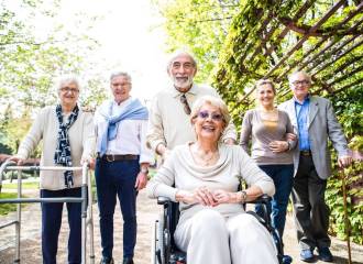 A group of older people walking in the park on a sunny day